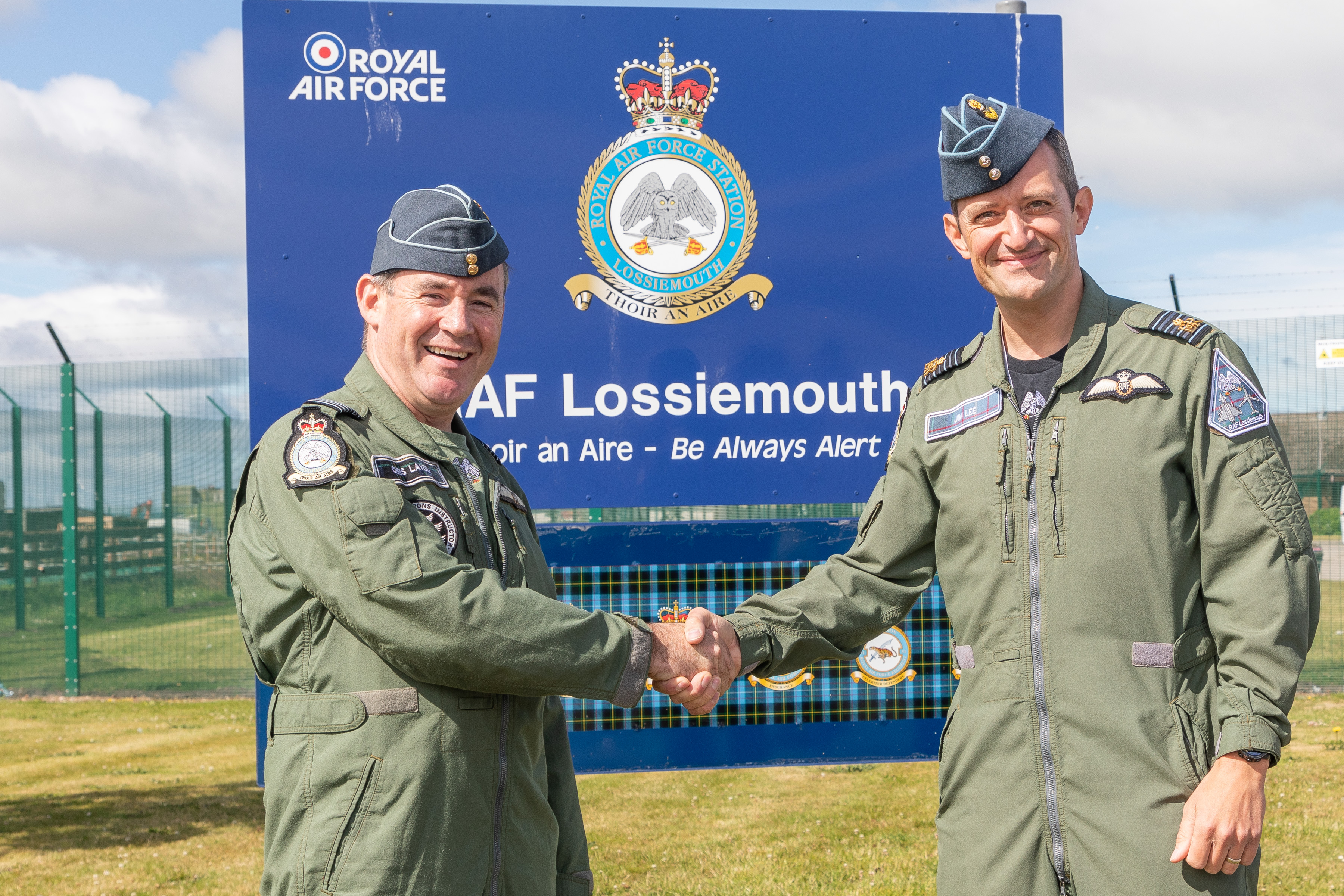 Image shows two aviators shaking hands.